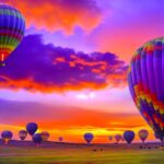 Hot air balloon drifting over a landscape at sunrise